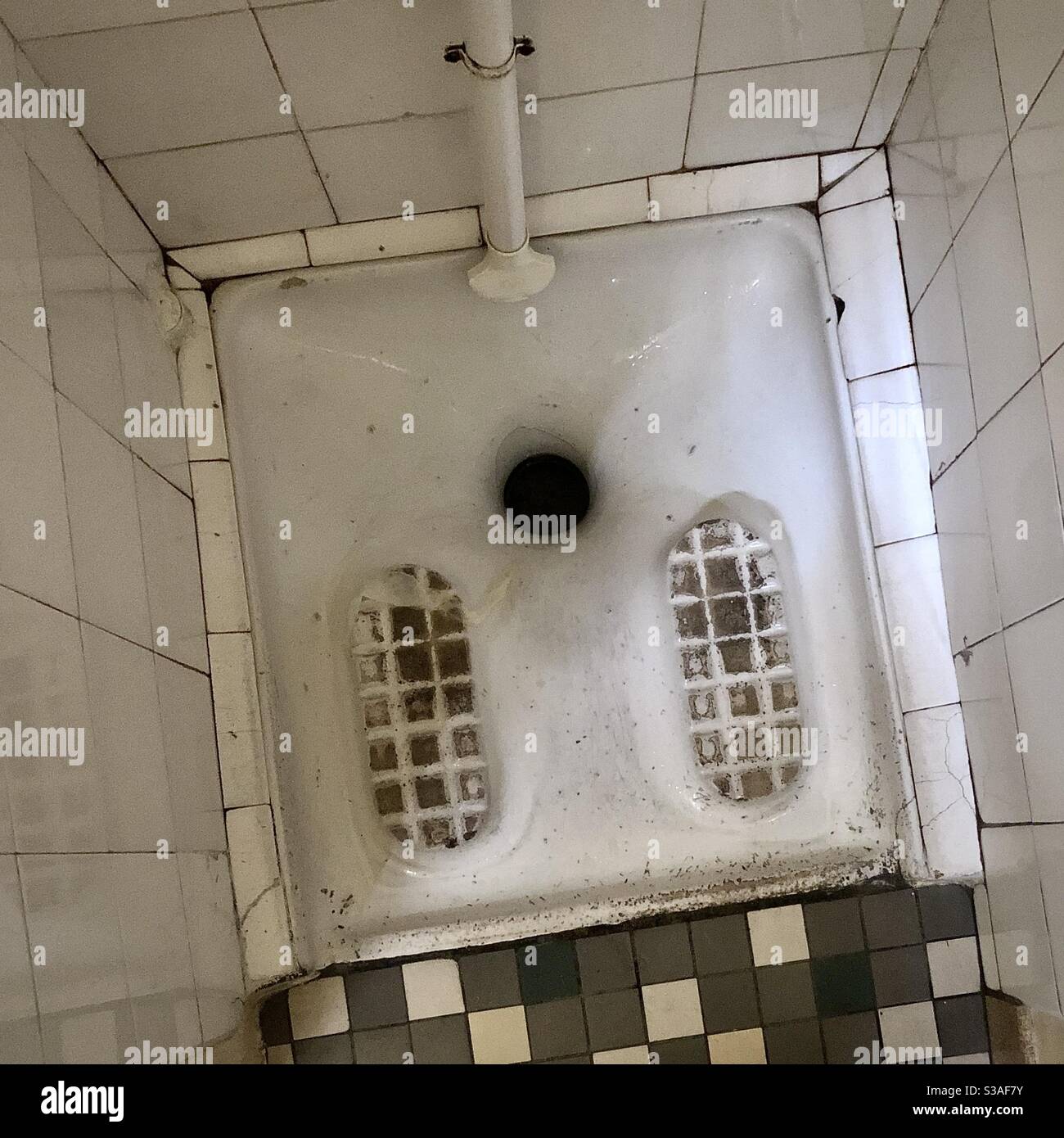 Traditional “Turkish” squat toilet in old French café - Bourges, France. Stock Photo
