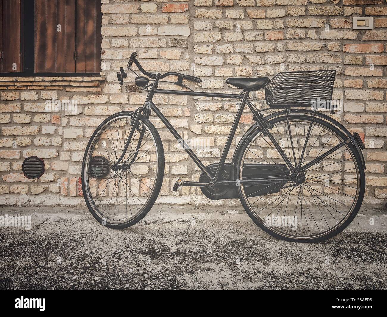 Bicycle in front of a brick wall - Smartphone Captured Stock Image