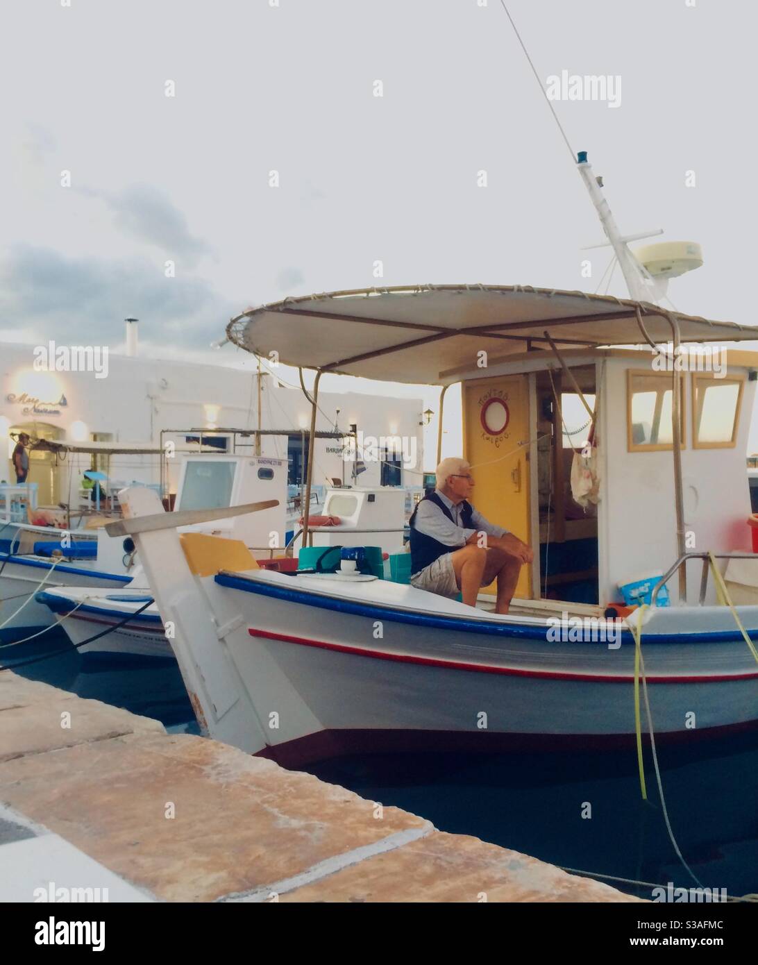 Fisherman at Paros on a traditional Greek fishing boat Stock Photo Alamy