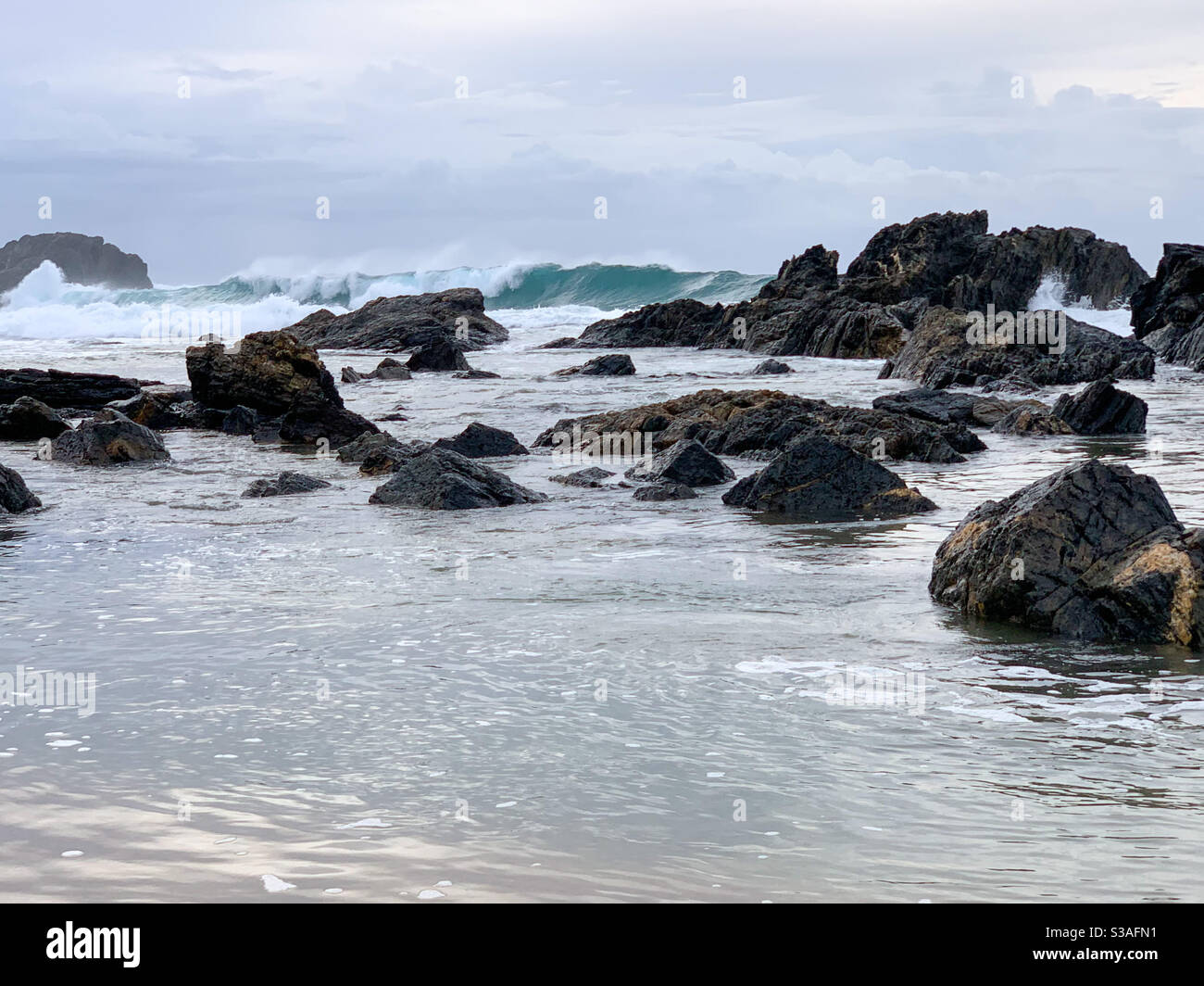 Waves rolling in through the rocks to the shore - Smartphone Captured Stock Image