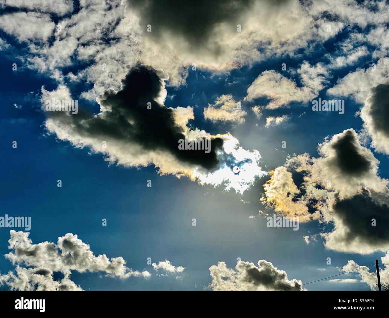 Clouds and sun shining through Stock Photo