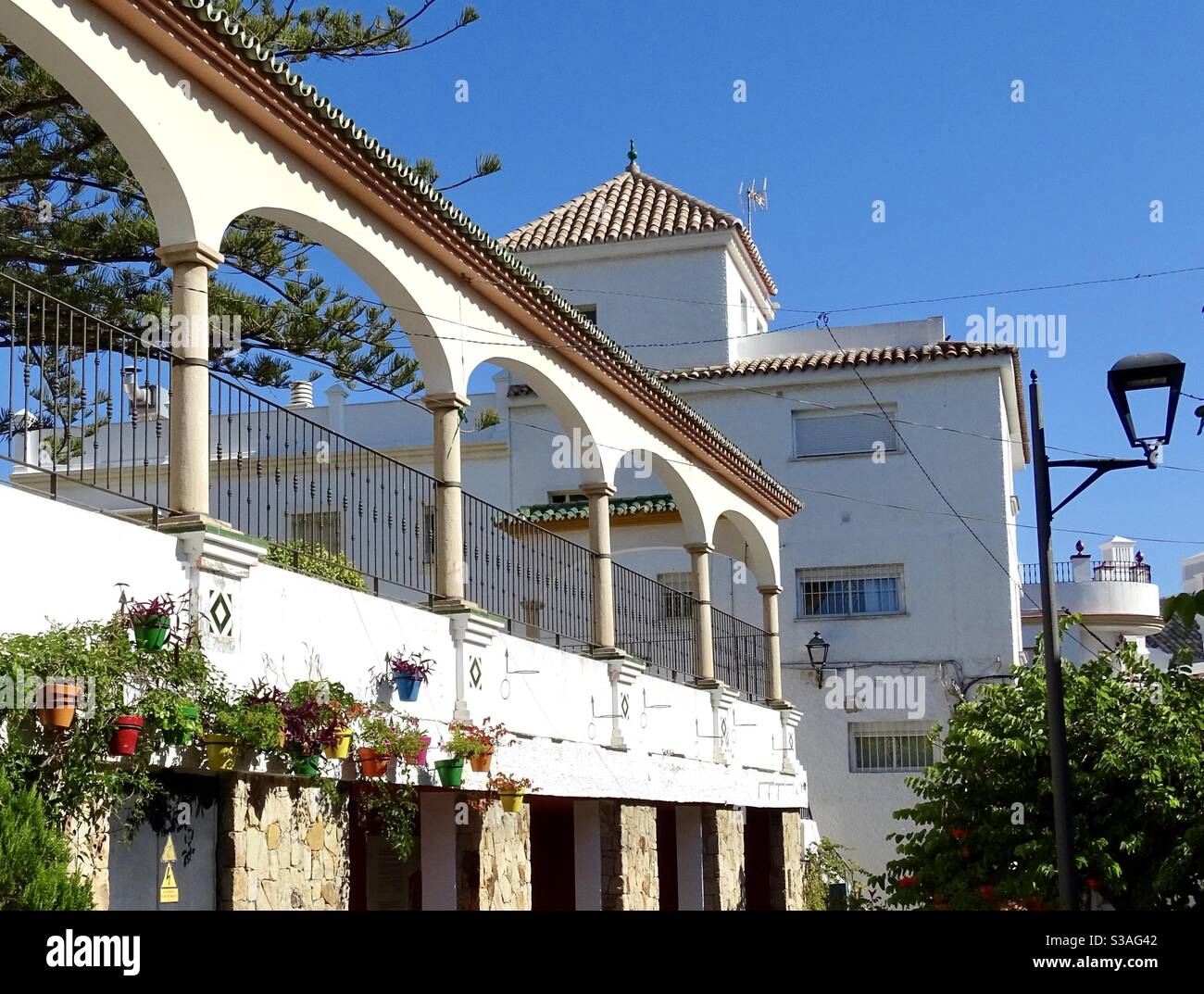 Flower displays outside building with arches in Estepona in southern Spain Stock Photo