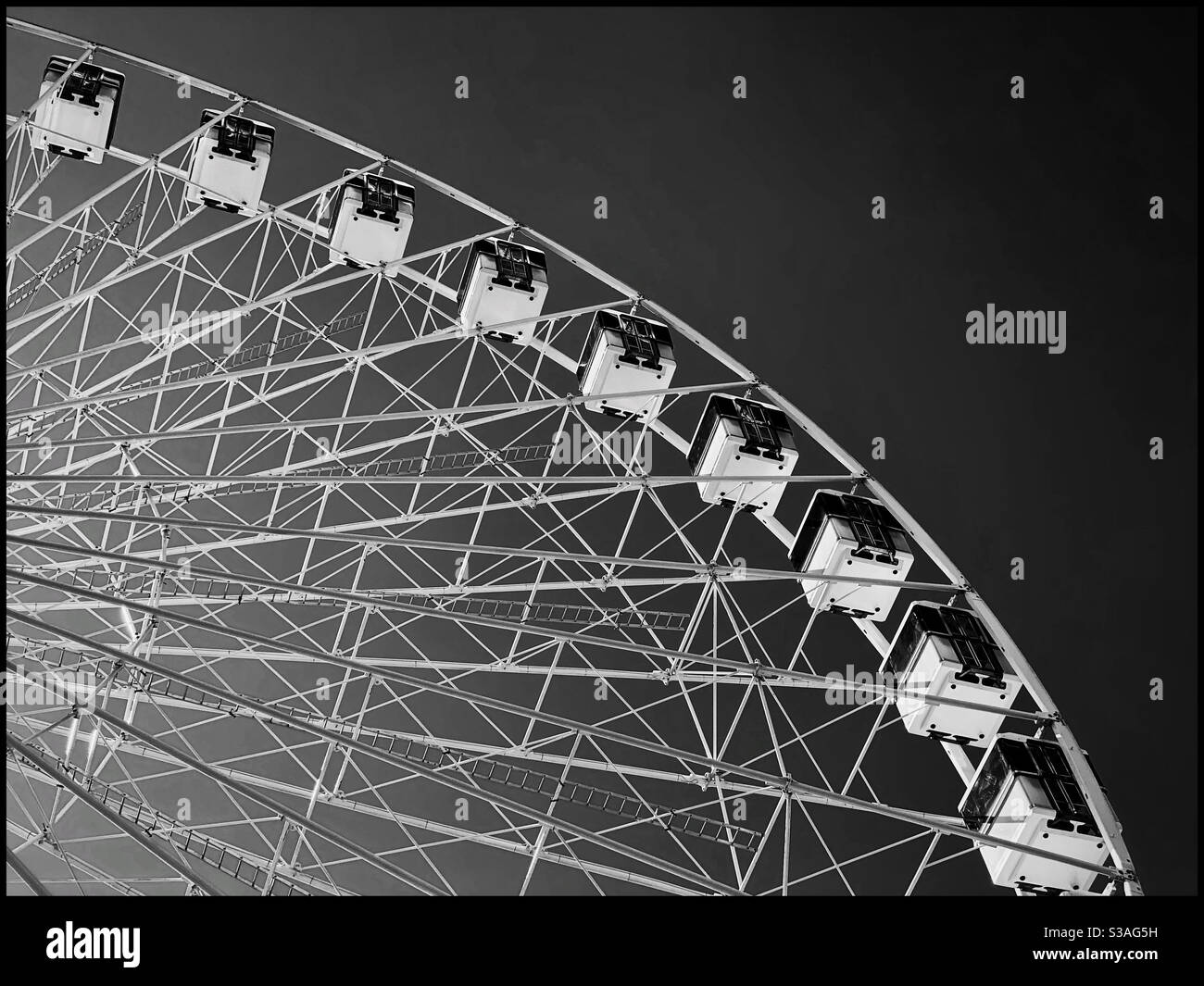 Looking up at a Ferris Wheel ride at a fun fair. Bright sunshine means a dark sky?! Photo Credit - ©️ COLIN HOSKINS. - Smartphone Captured Stock Image
