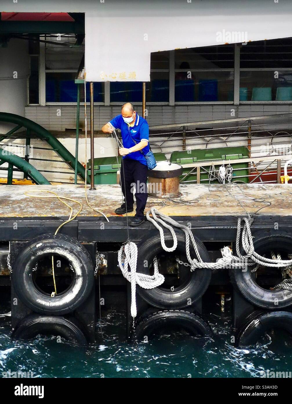 a ferry worker at the pier. - Smartphone Captured Stock Image