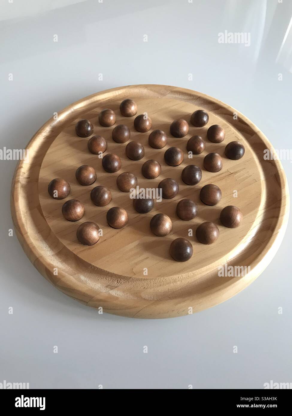 Wooden peg solitaire board game Stock Photo Alamy