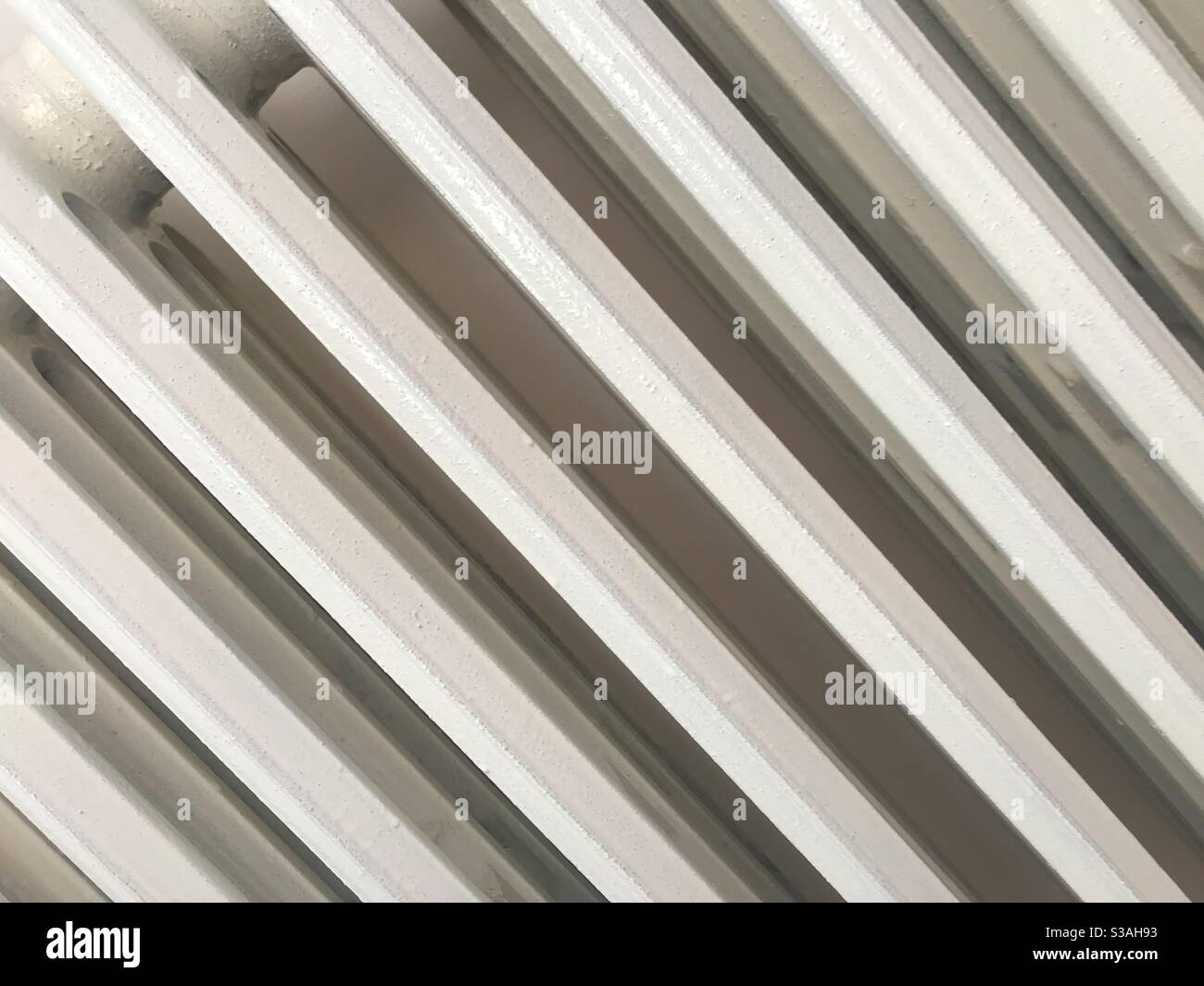 A white indoor radiator seen from an angle - Smartphone Captured Stock Image