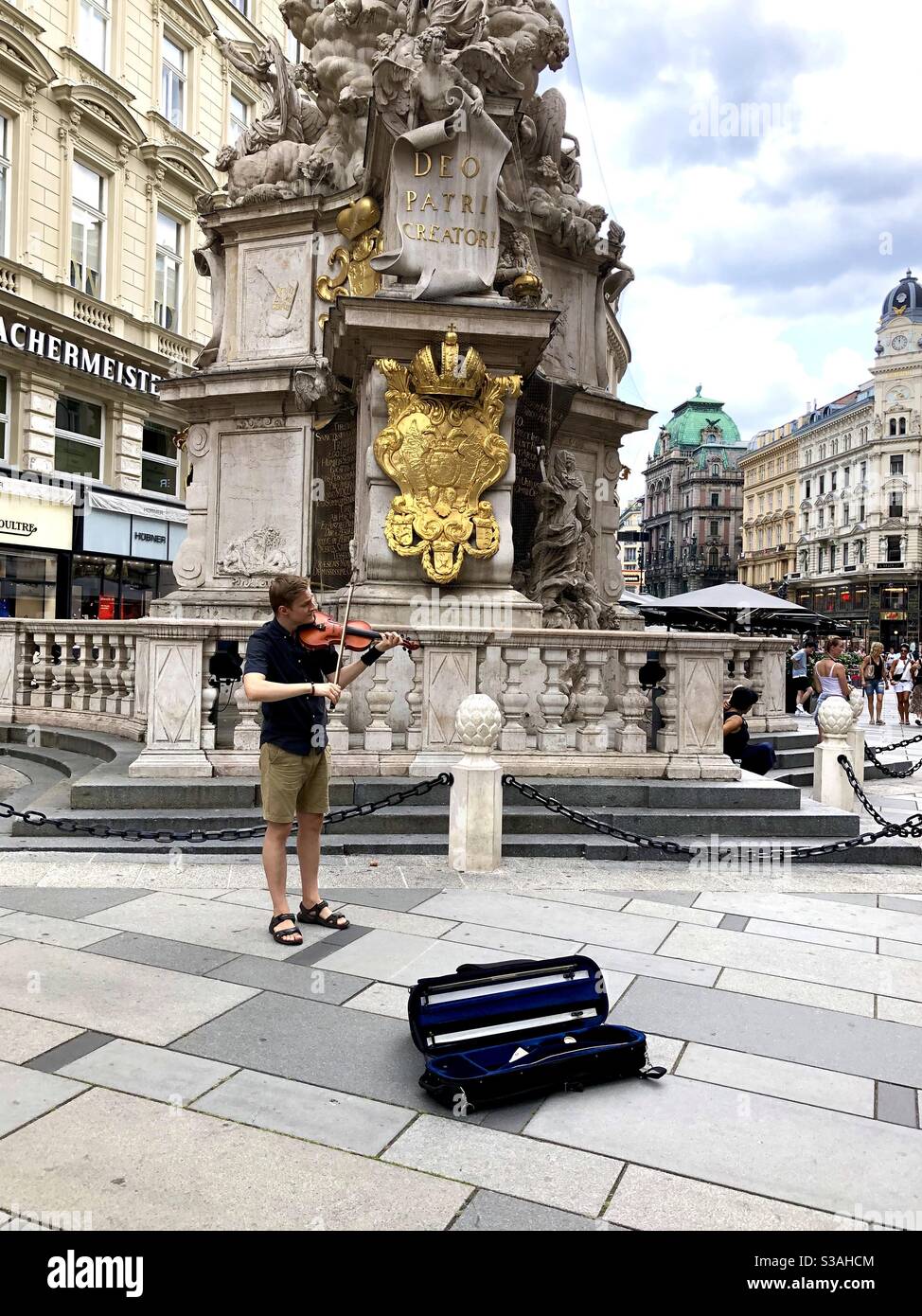A young male musician playing the violin in Hofburg Plaza, Vienna, Austria playing for tips. - Smartphone Captured Stock Image