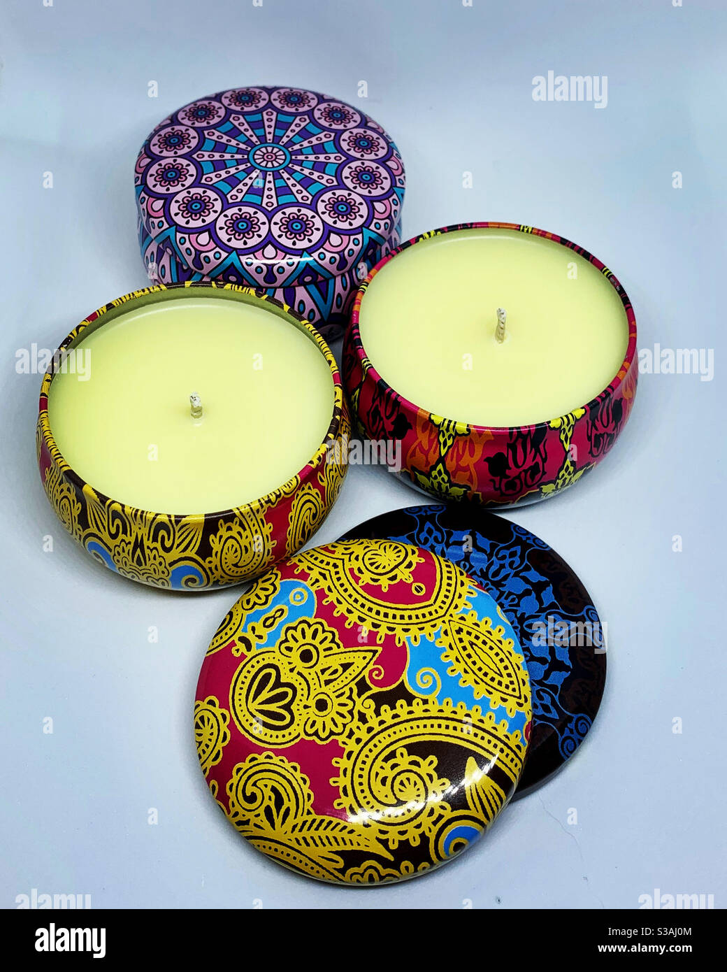 Colorful, paisley Boho tins made into scented soy wax candles. I hand pour these candles. Stock Photo