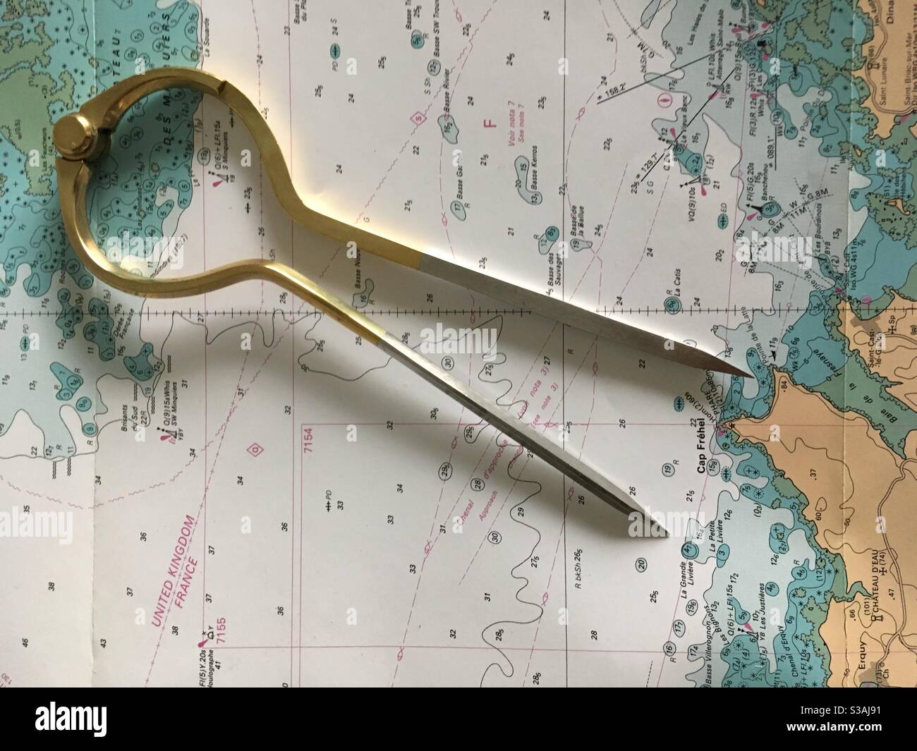 maritime chart with brass navigation circle - Smartphone Captured Stock Image