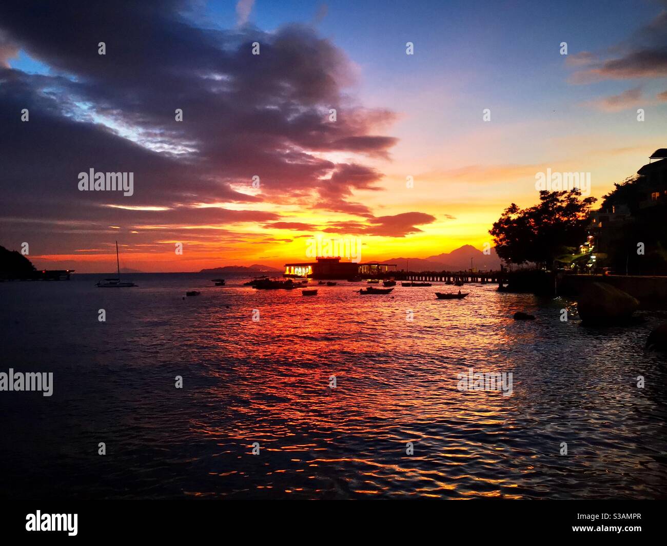 A beautiful sunset over the Yung shue wan pier on Lamma island in Hong kong. - Smartphone Captured Stock Image