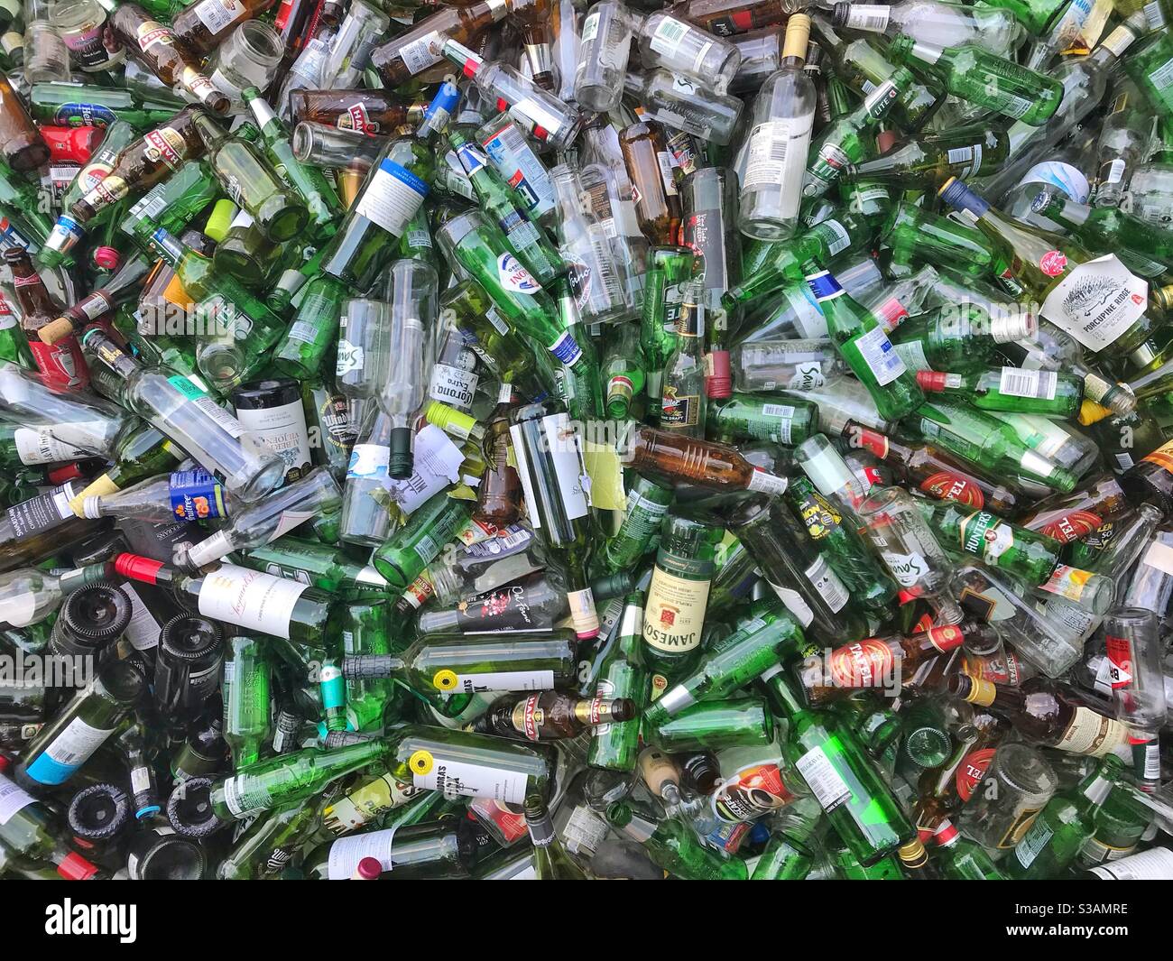 Empty glass bottles in a recycling skip. - Smartphone Captured Stock Image
