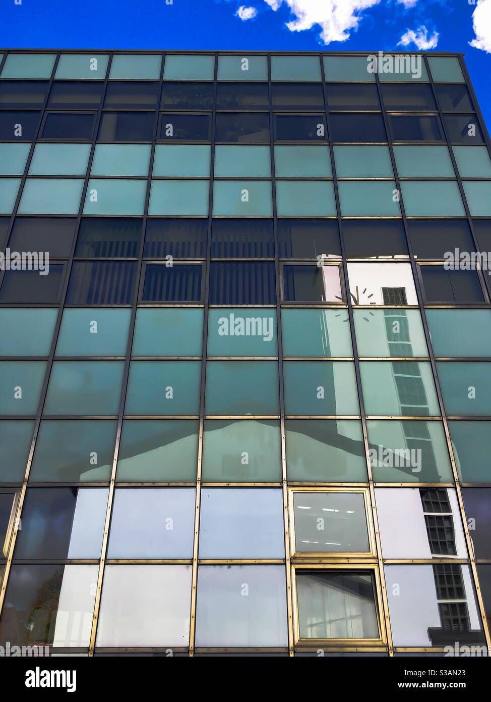 glass facade of mpdern building reflecting old church - Smartphone Captured Stock Image