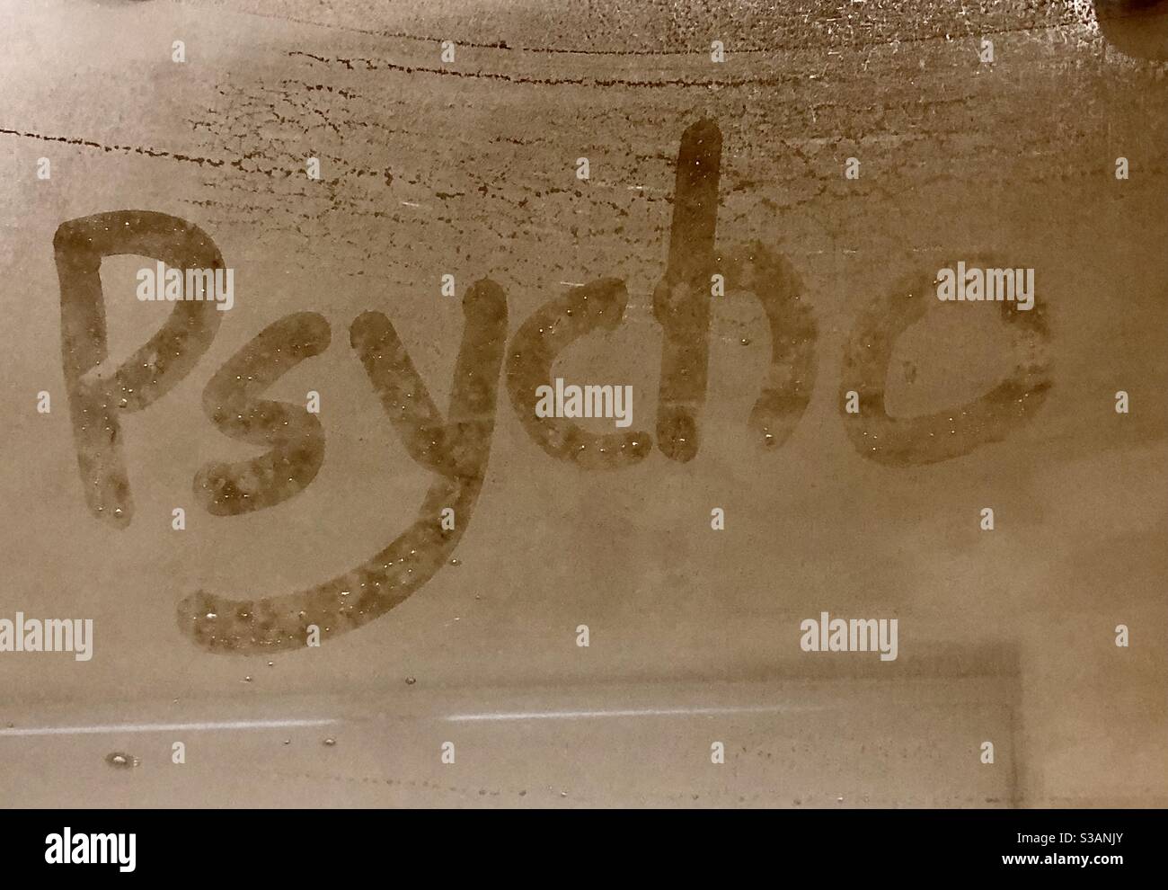 The word Psycho written in the condensation on a shower screen Stock Photo