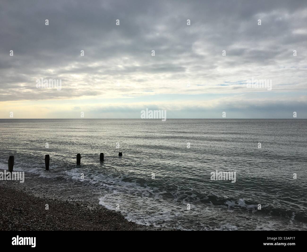 Groyne posts in stormy grey sea - Smartphone Captured Stock Image