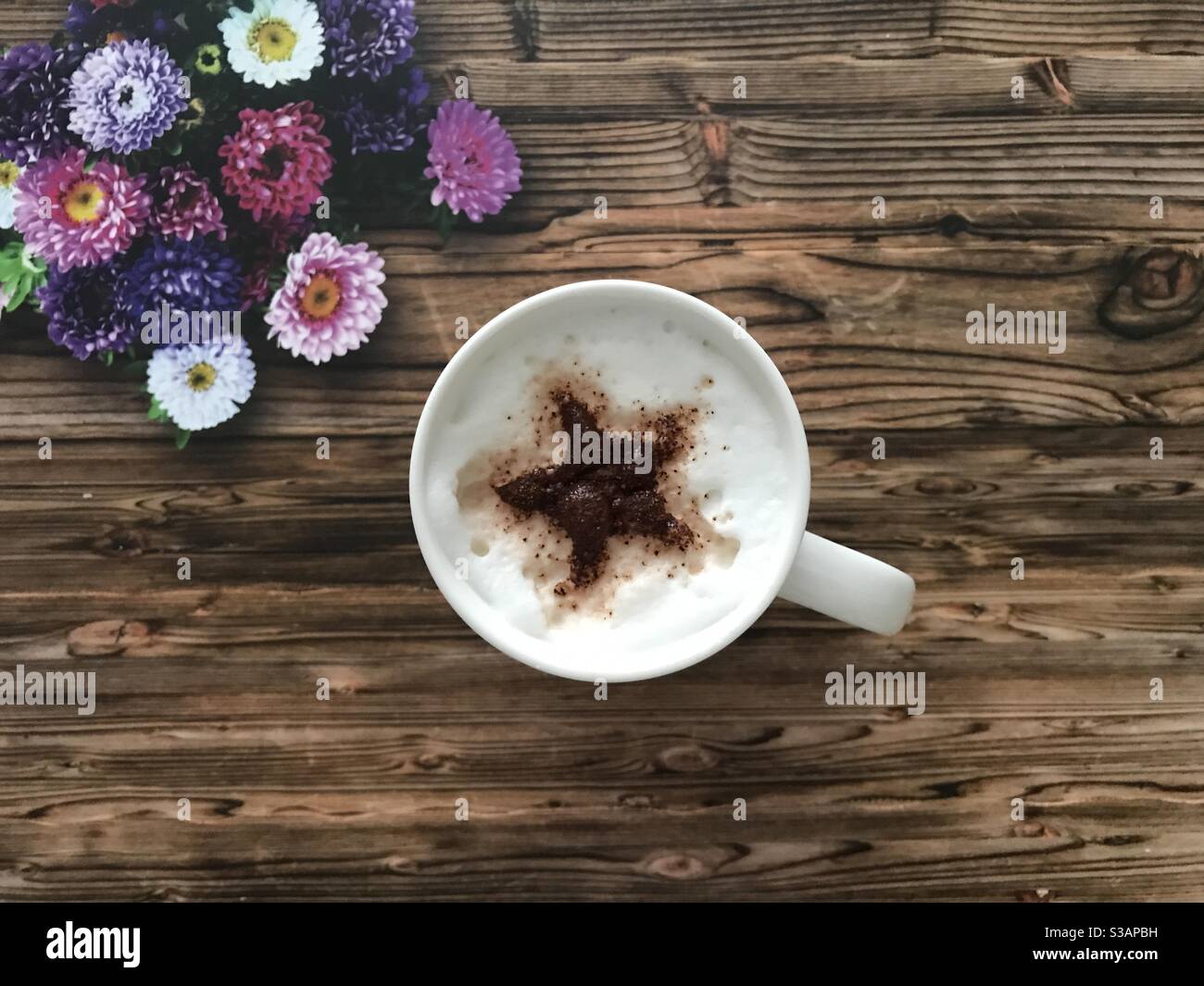 Star shaped design on a cappuccino coffee - Smartphone Captured Stock Image