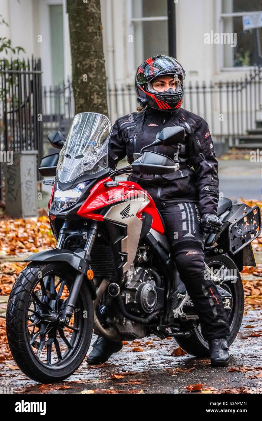 A female biker on a Honda motorcycle in Autumn Stock Photo