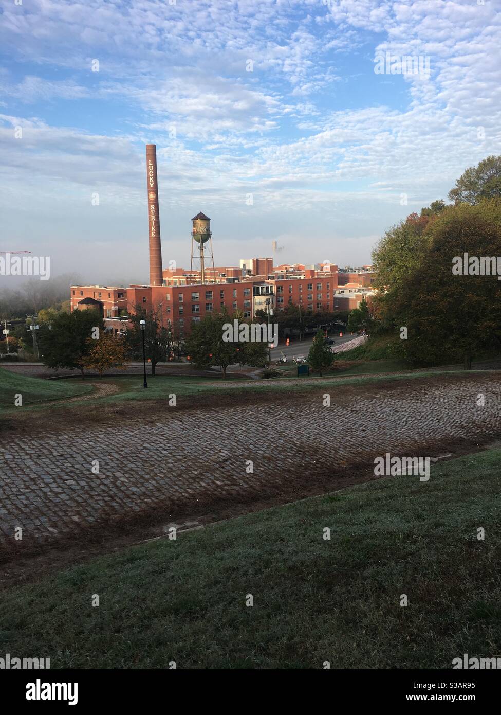 A foggy fall morning photo of the Lucky Strike building in Richmond Virginia. Stock Photo