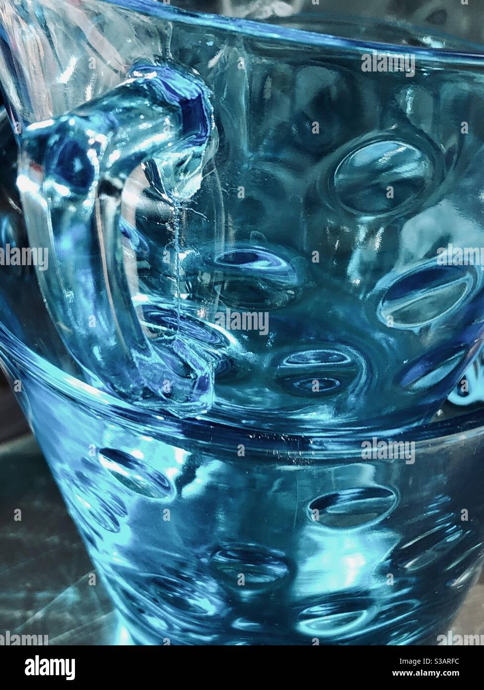Stack of turquoise blue glass teacups ready - Smartphone Captured Stock Image