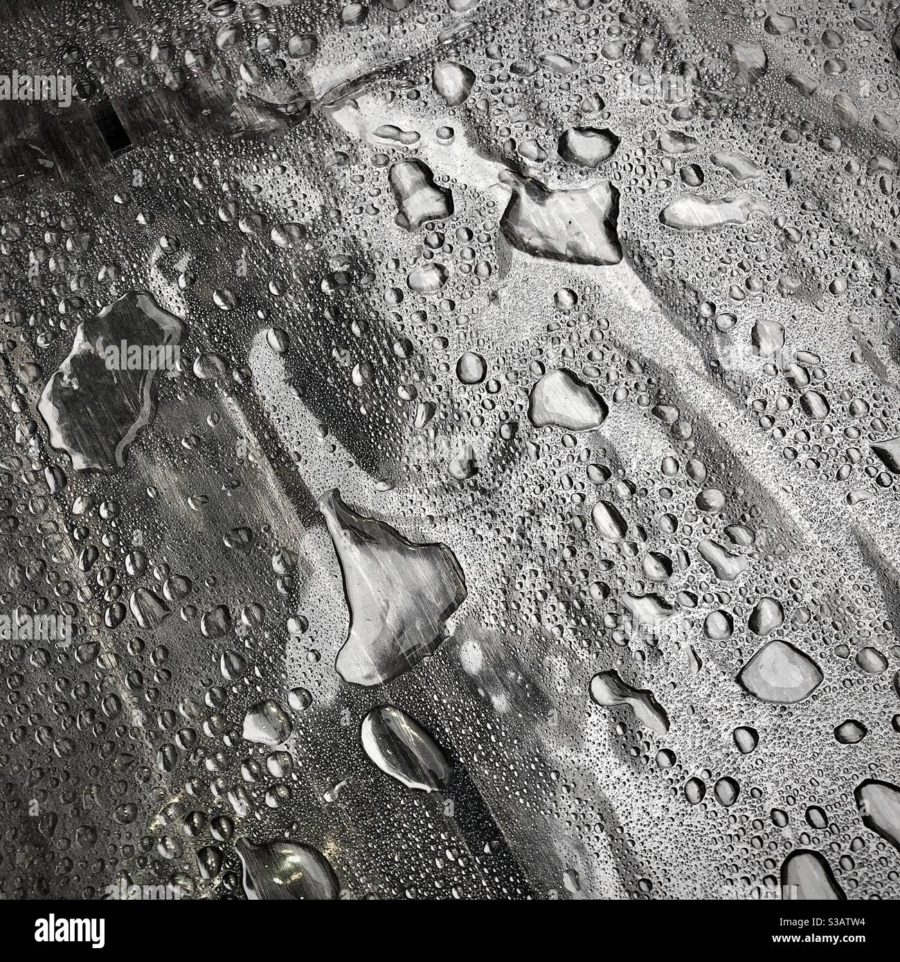 Rainwater collecting on plastic covered café table. - Smartphone Captured Stock Image
