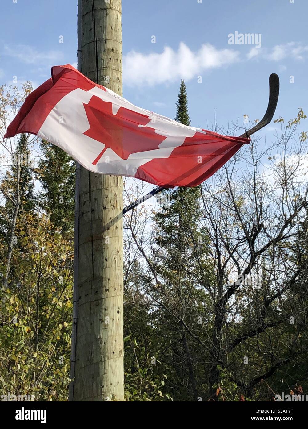 Canadian flag on hockey stick Stock Photo Alamy