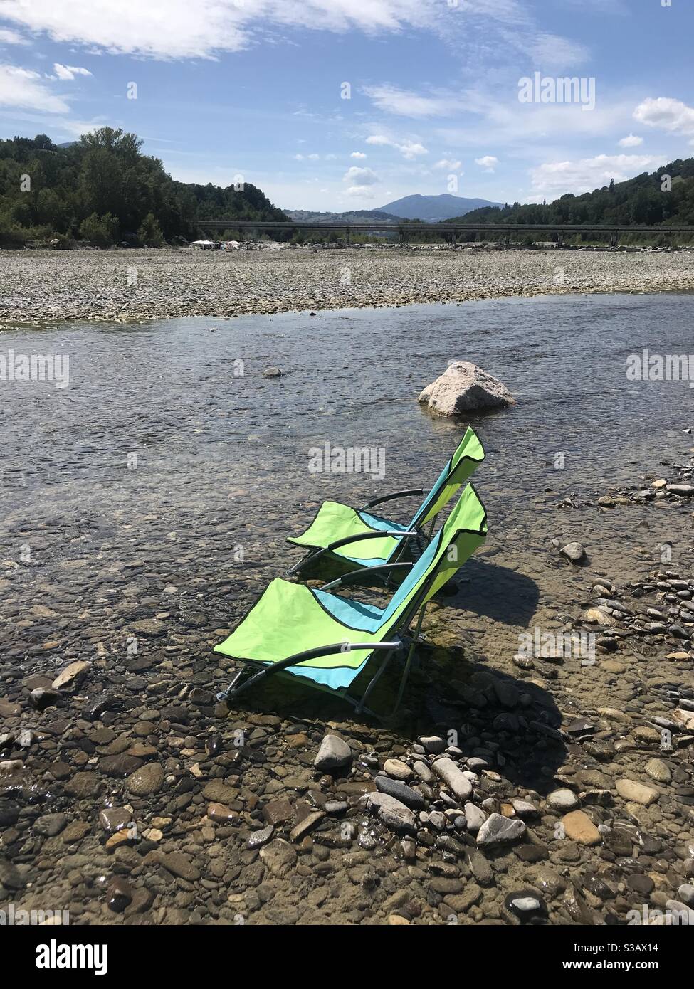 Two camping chairs in the river - Smartphone Captured Stock Image