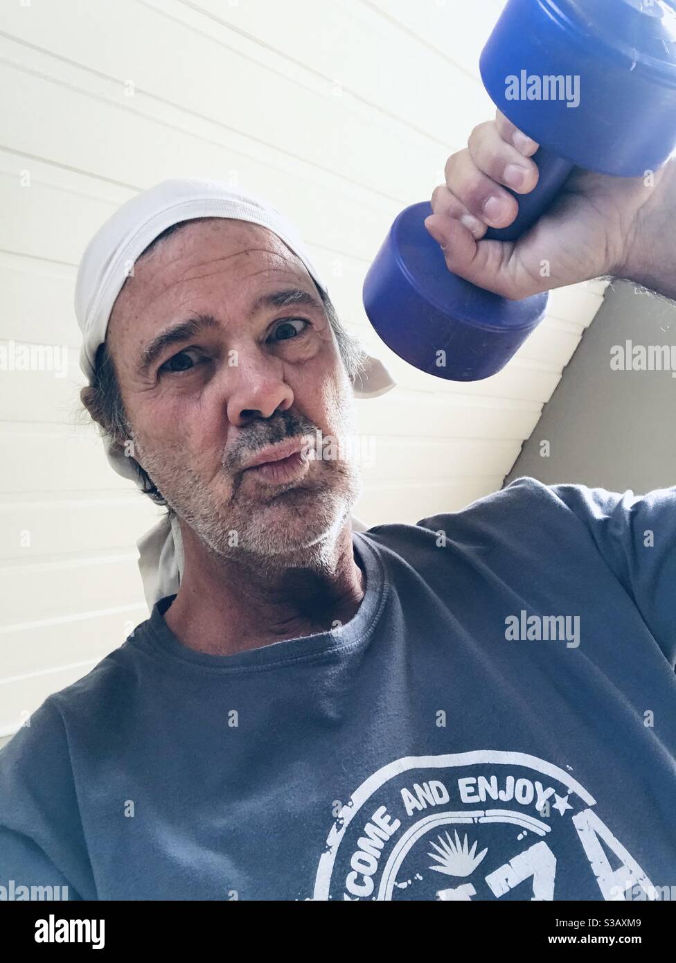 Old man doing home fitness Stock Photo