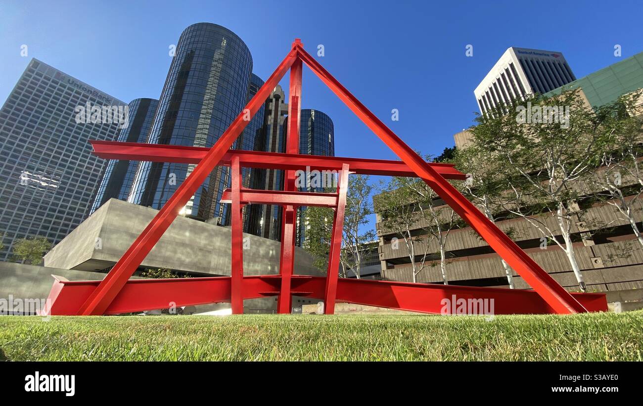 LOS ANGELES, CA, JUL 2020: bright red, steel sculpture 'Shoshone' by Mark DiSuvero, 1982, outside the Citigroup Center in Downtown, with Westin Bonaventure hotel in background - Smartphone Captured Stock Image