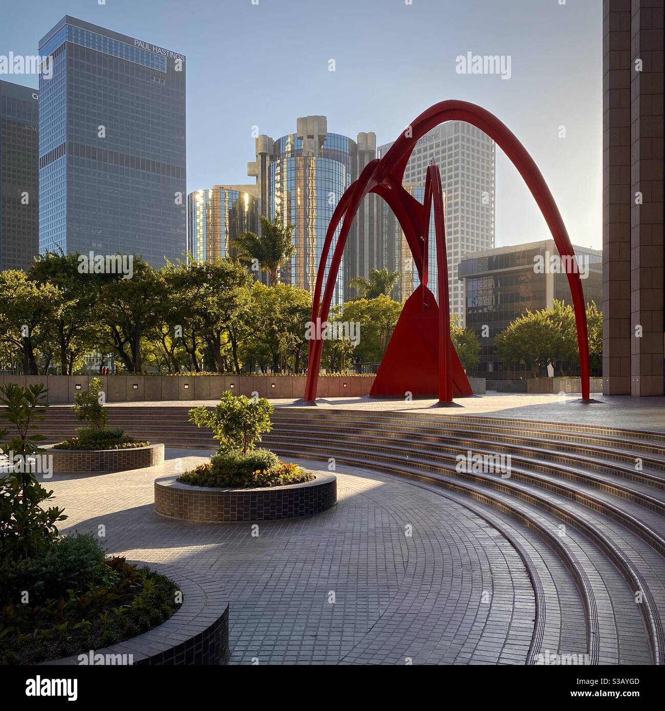 LOS ANGELES, CA, JUL 2020: bright red steel, Four Arches 'stabile'by Alexander Calder at Bank of America Plaza, with curving pavement features designed to complement the sculpture in Downtown Stock Photo