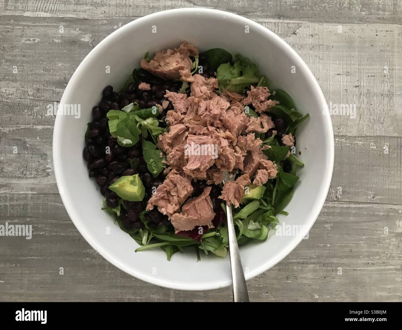 Tuna, bean and avocado salad served in a white bowl - Smartphone Captured Stock Image