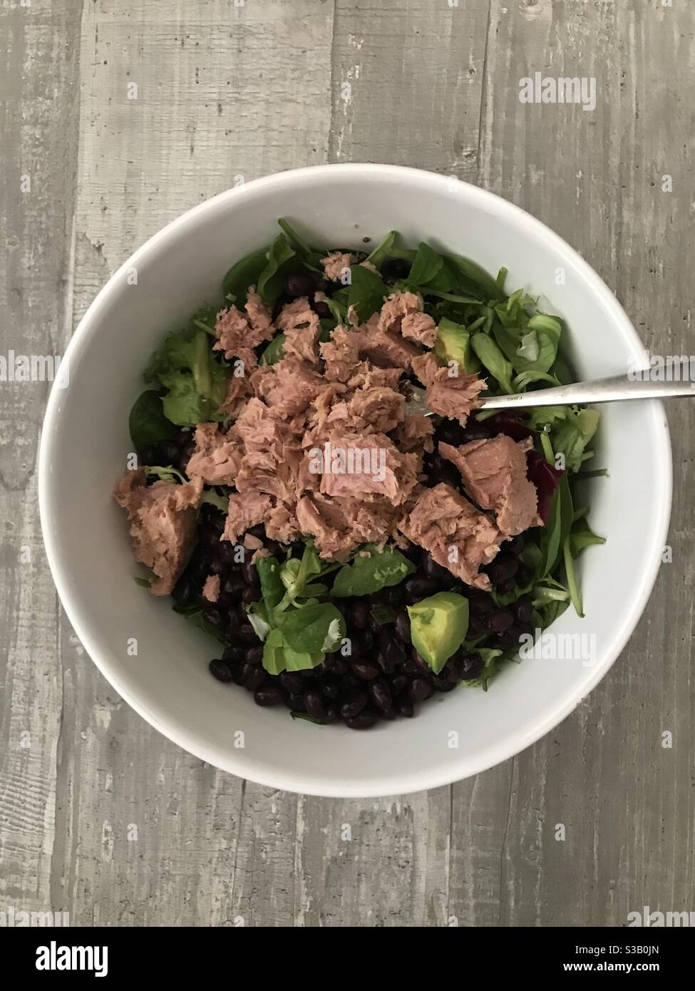 Tuna, bean and avocado salad served in a white bowl - Smartphone Captured Stock Image