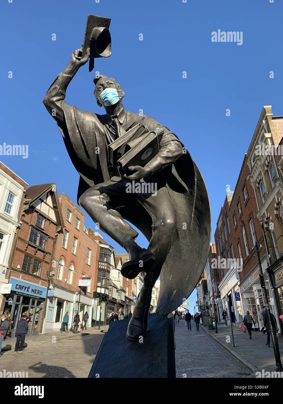 Surrey scholar statue wearing mask - Smartphone Captured Stock Image