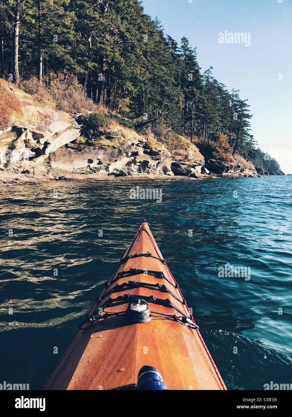Paddling along beautiful coastline near Bellingham WA Stock Photo
