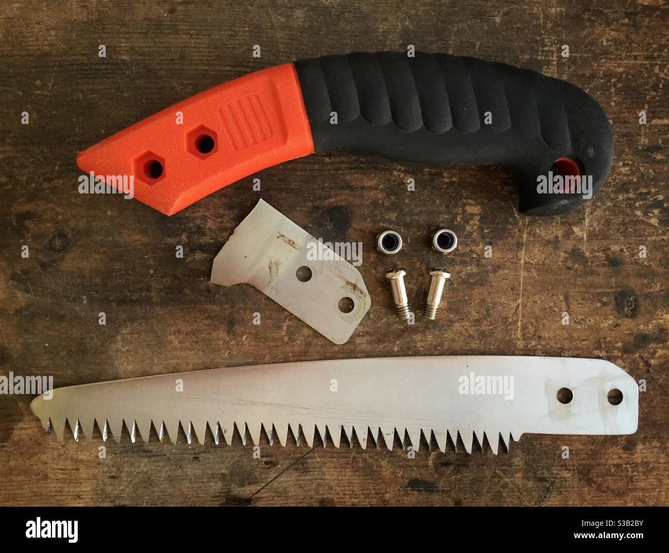 Fabricating a repair to a broken hand pruning saw, Catalonia, Spain. - Smartphone Captured Stock Image