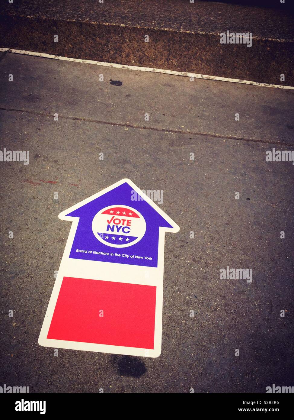 Sidewalk directional arrows pointing to polling places on the presidential election 3 November 2020, New York City - Smartphone Captured Stock Image