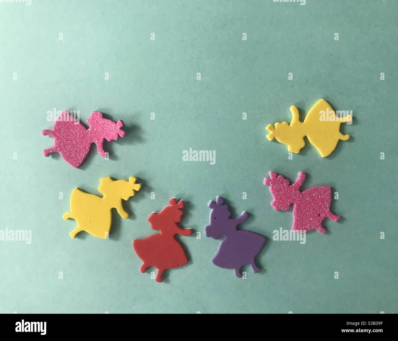 Colourful princesses on a turquoise background - Smartphone Captured Stock Image