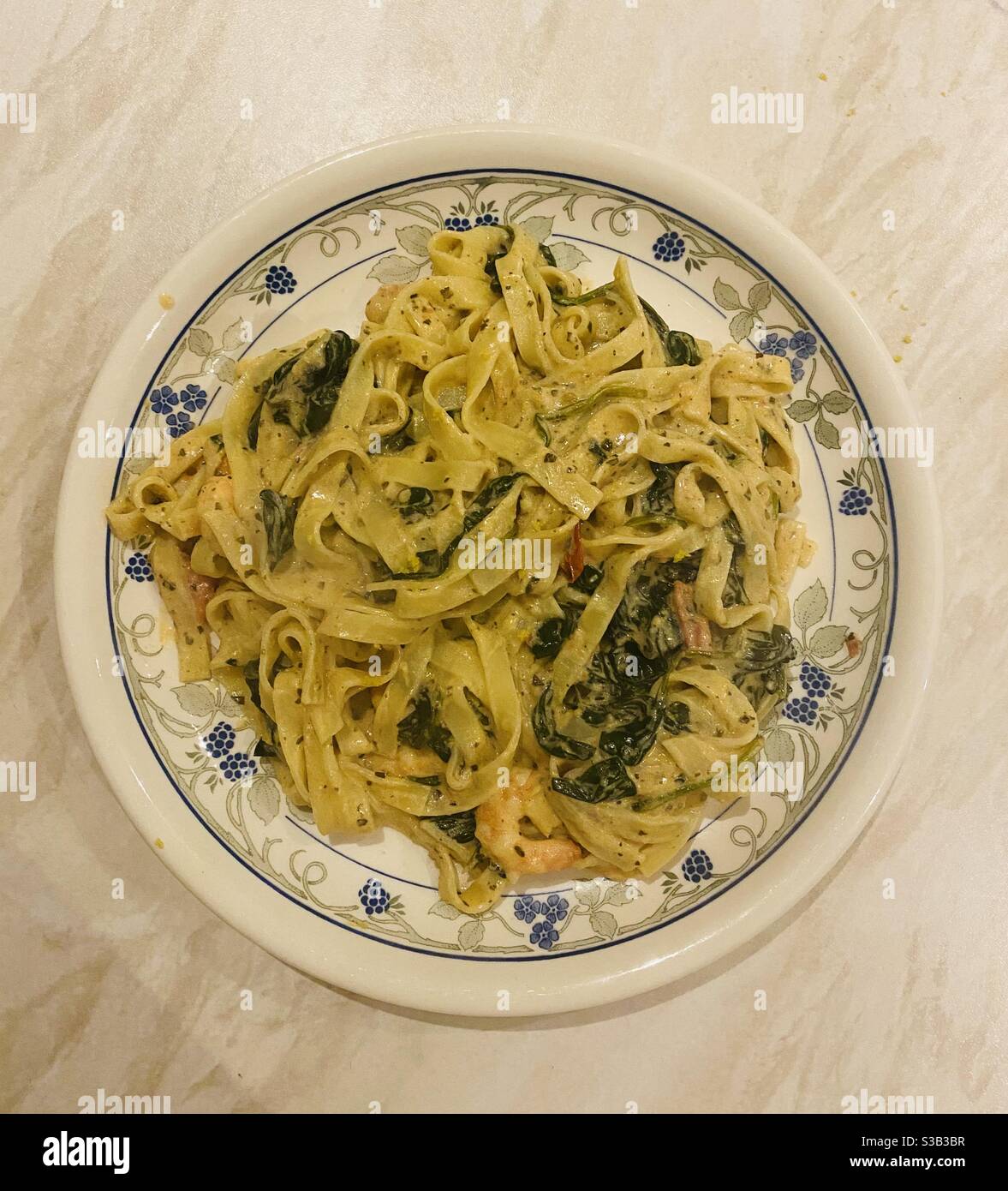 King Prawns and Fresh Tagliatelle with Creamy Lemon Pesto Sauce, Spinach and Tomatoes. - Smartphone Captured Stock Image