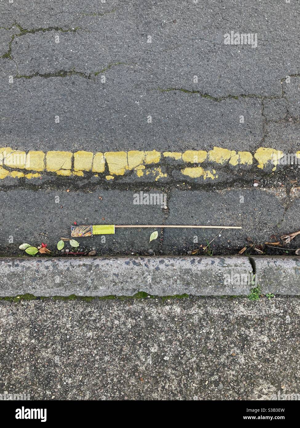 Rubbish from a used firework in a gutter - Smartphone Captured Stock Image