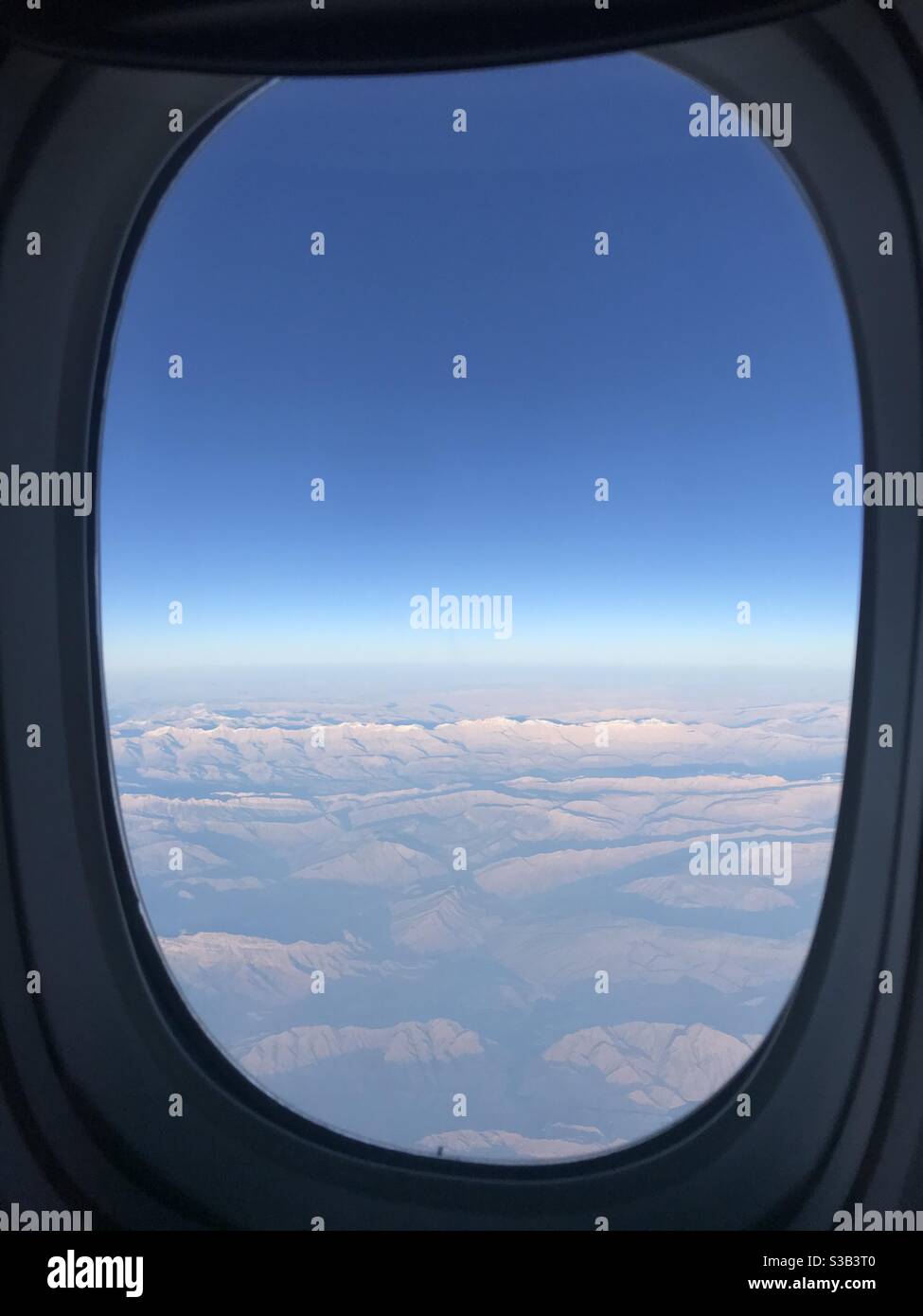 View of the clouds taken from an airplane window mid flight - Smartphone Captured Stock Image