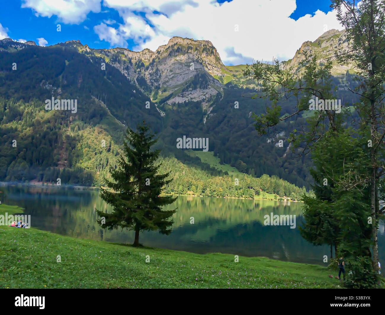 lake surrounded by mountain scene reflecting in water Stock Photo