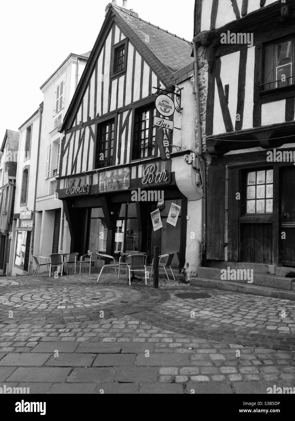 A cobblestone street with half-timbered homes and businesses in the town of Laval, France, west of Paris. - Smartphone Captured Stock Image