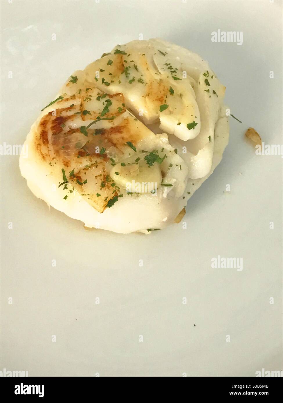 Grilled hake loin with garlic and parsley Stock Photo Alamy