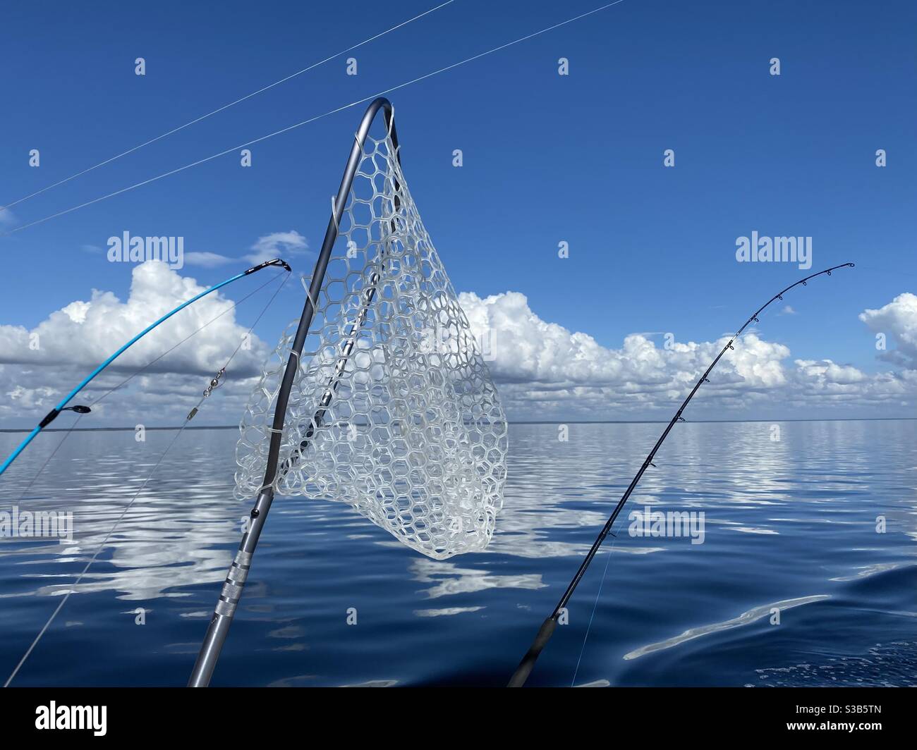 Fishing poles and fishing net with view of deep blue Gulf of Mexico water  Stock Photo - Alamy