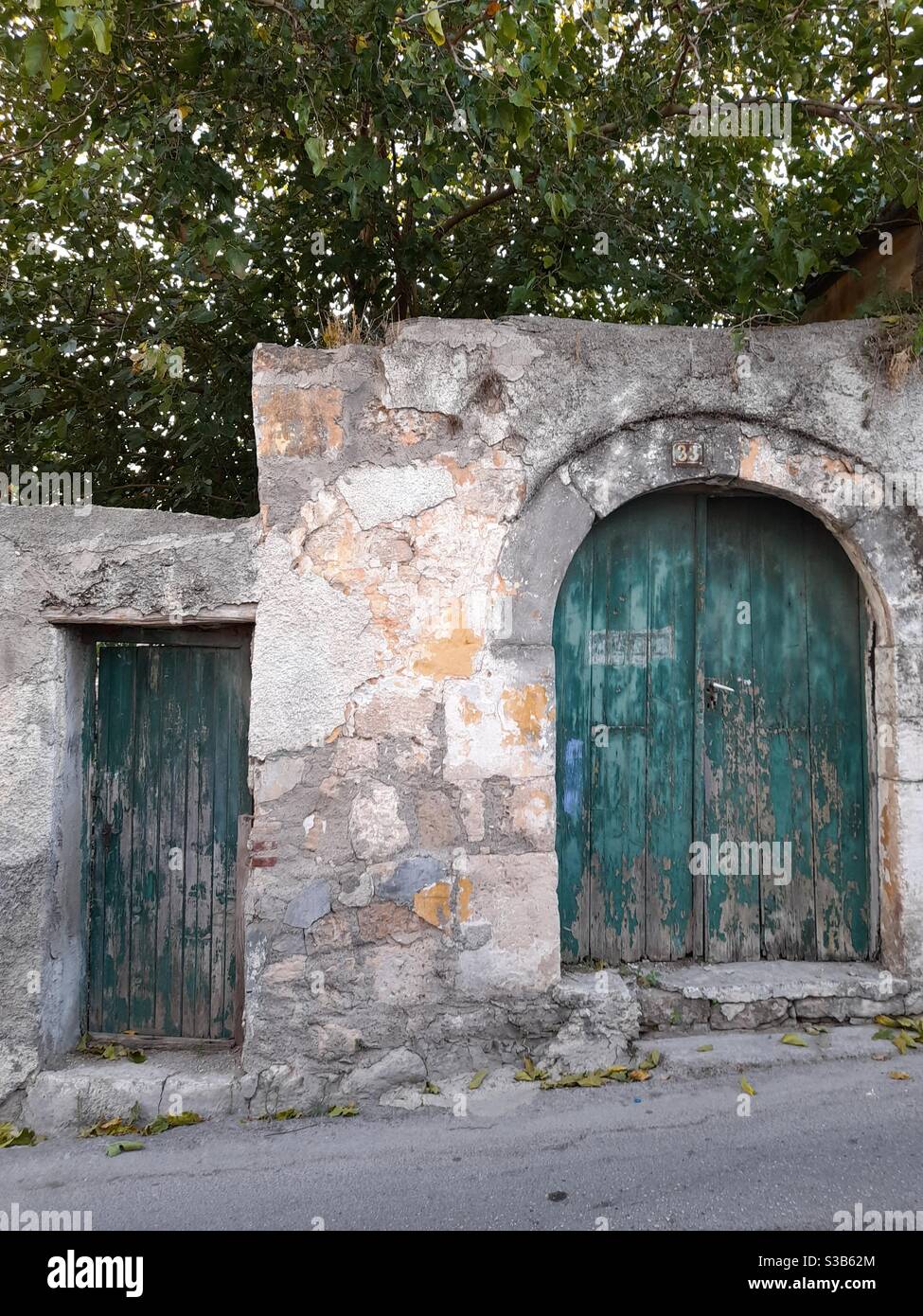 Traditional wooden doors in Aegina town, in Aegina island, near Athens, Greece, Europe - Smartphone Captured Stock Image