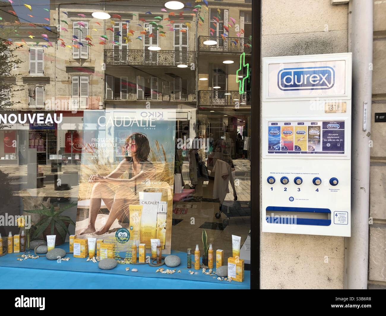 Durex vending machine on the wall outside a pharmacy in France - Smartphone Captured Stock Image