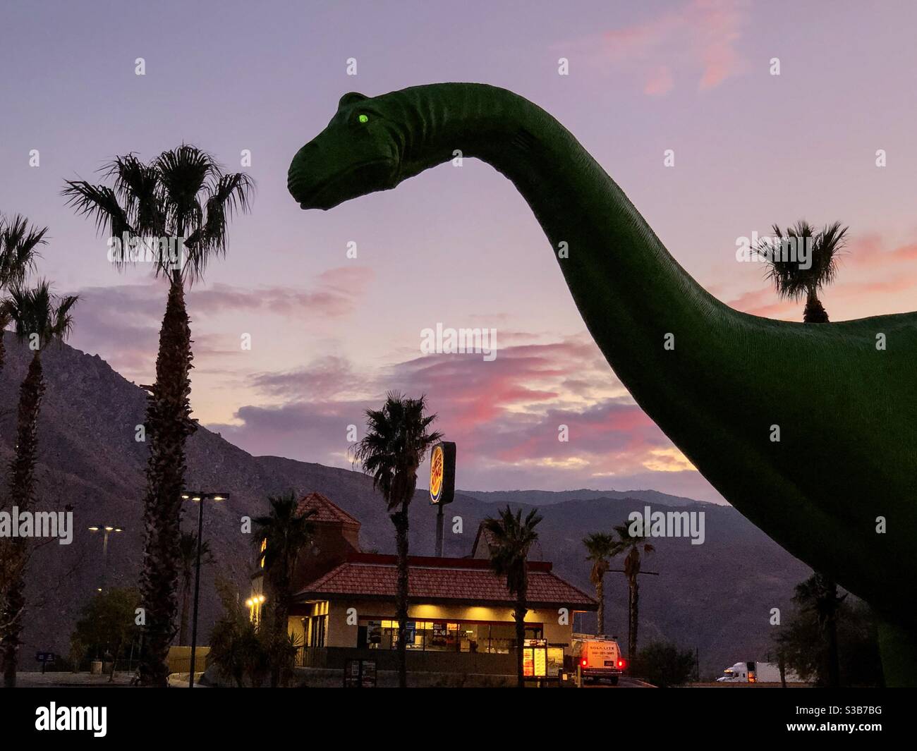 Palm Springs, USA. 12th Nov, 2020. The Cabazon dinosaurs outside Palm Springs at sunset. - Smartphone Captured Stock Image
