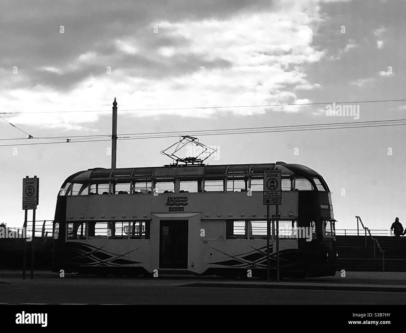 Vintage Blackpool tram on the front, silhouetted against a dramatic winter sky, north west England UK Stock Photo