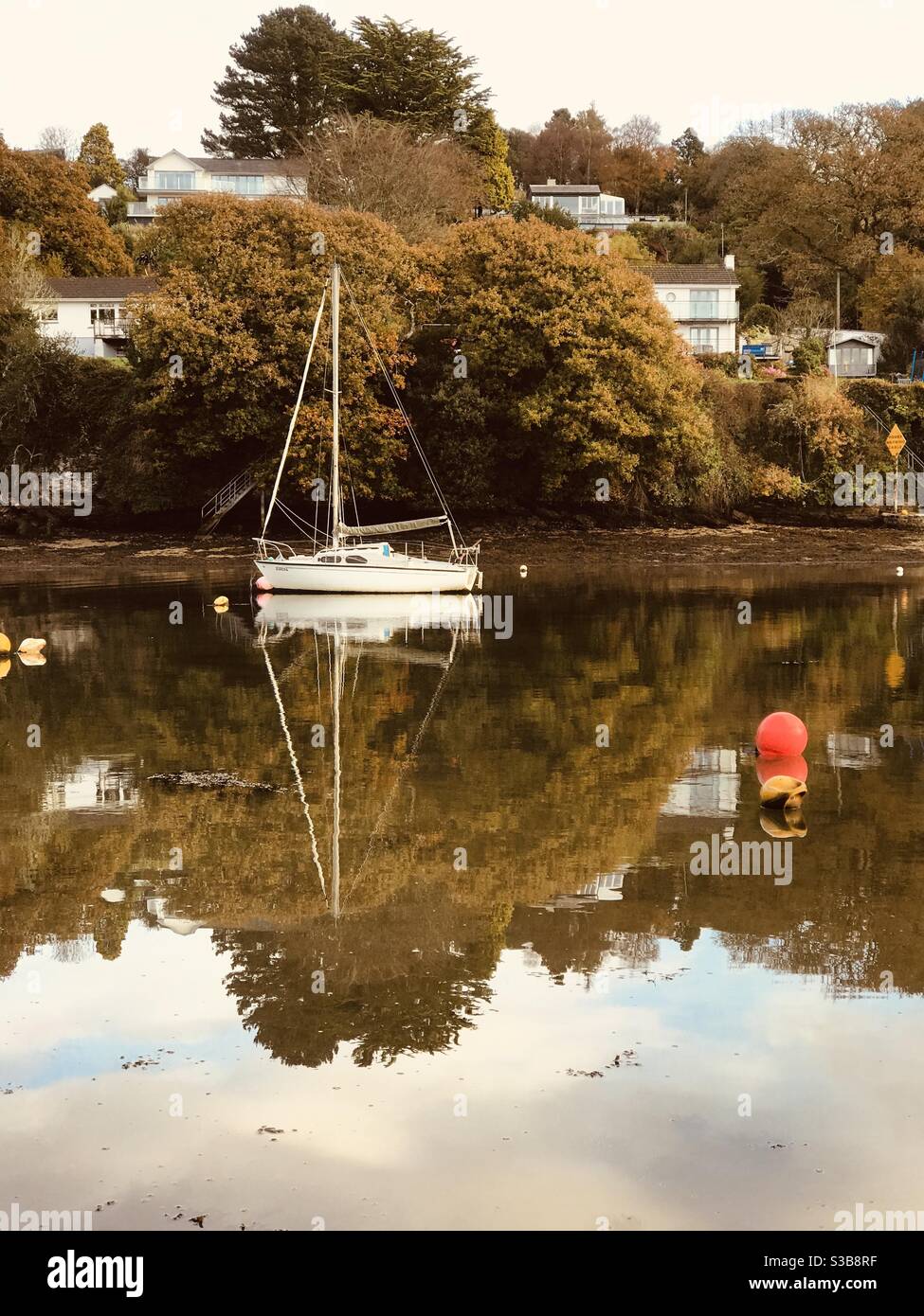 a solitary yacht reflected in Pill Creek - Smartphone Captured Stock Image