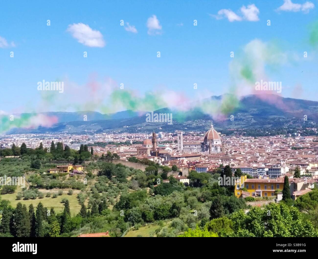 Florence city from San MINIATO al Monte church the parade of Frecce Tricolori airplanes celebrating the Italian republic day festivity on the second of June 2020. Colored smoke remains in the sky. Stock Photo