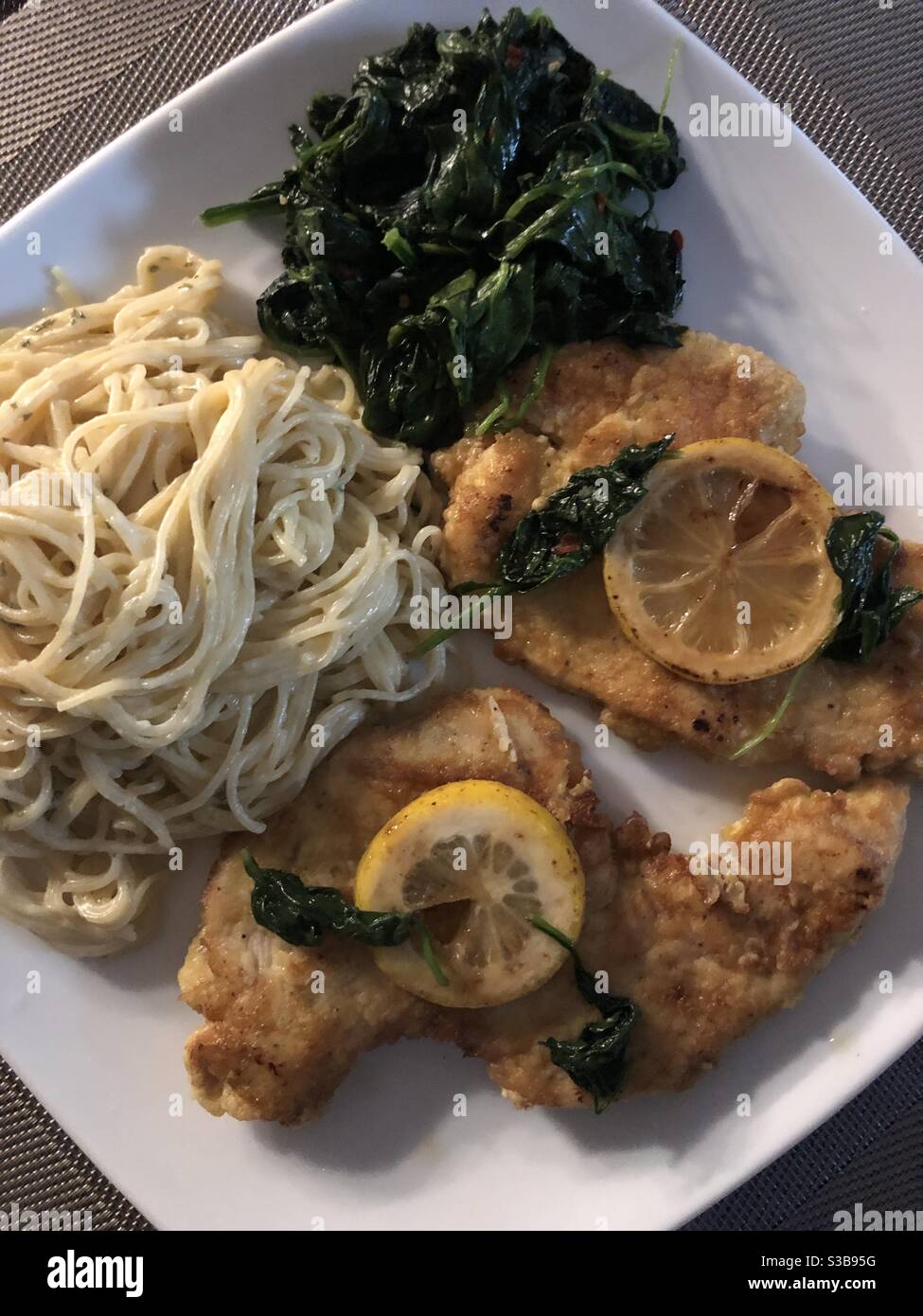 Chicken francese with spinach and pasta Stock Photo Alamy