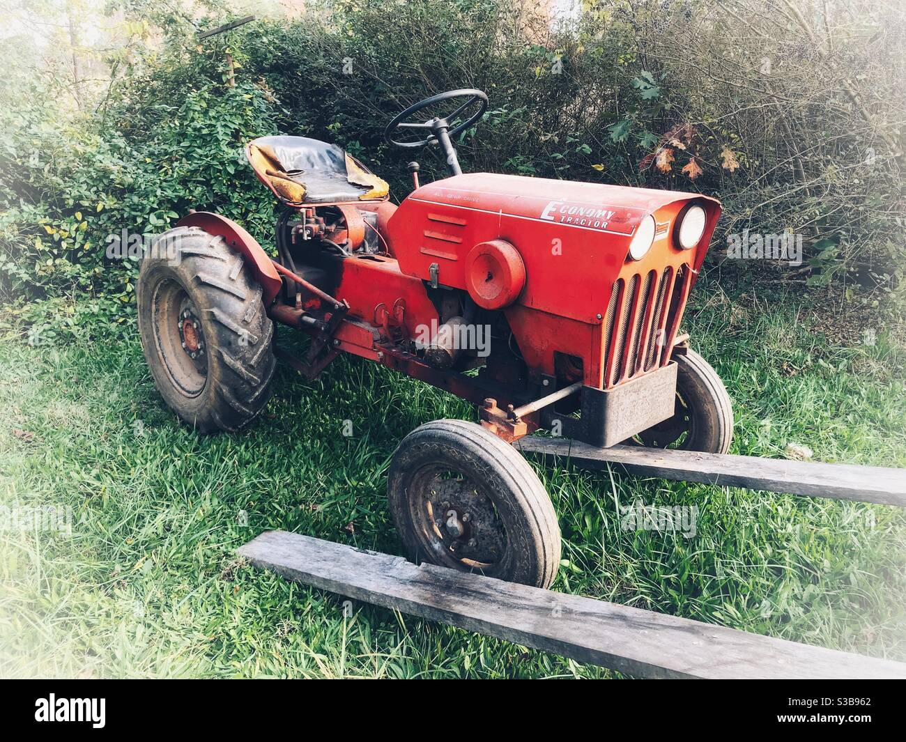 Vintage orange tractor in late afternoon - Smartphone Captured Stock Image